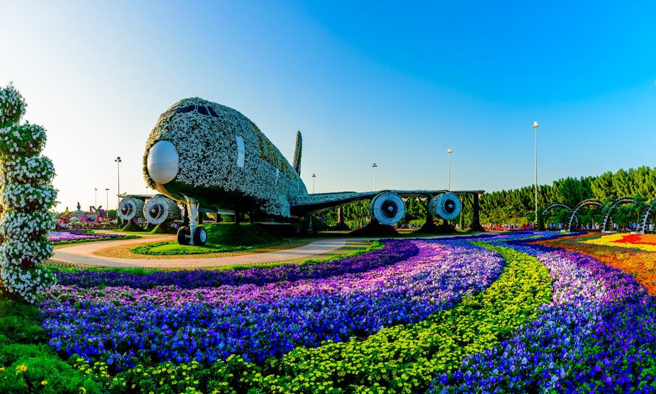 hero-gallery-03 Vibrant floral Airbus A380 installation at Dubai Miracle Garden, surrounded by colorful flowers and lush landscape.