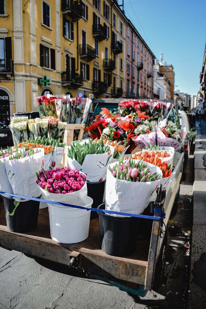 about-img Bustling flower market with vibrant bouquets in Milan's lively streets.